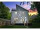 Exterior view of a modern home at sunset, showcasing a deck, backyard, and rooftop terrace at 2186 Park Terrace, College Park, GA 30337