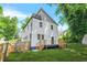 A modern home features a fenced yard, wooden deck, and stairs leading down to a lush, green lawn at 2186 Park Terrace, College Park, GA 30337