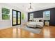 Bright bedroom with hardwood floors, large windows, and a contemporary light fixture at 2186 Park Terrace, College Park, GA 30337