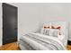 Bright bedroom with wooden floors, a modern bed, and a black door at 2186 Park Terrace, College Park, GA 30337