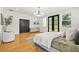 Modern bedroom featuring hardwood floors, stylish decor, and a large door at 2186 Park Terrace, College Park, GA 30337