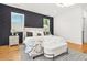 Modern bedroom with a striking accent wall, plush bedding, and stylish lighting at 2186 Park Terrace, College Park, GA 30337