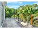 Relaxing deck featuring wood railing and views of lush trees at 2186 Park Terrace, College Park, GA 30337