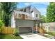 Modern two-story home showcasing a balcony, unique garage door, and professional landscaping at 2186 Park Terrace, College Park, GA 30337