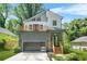 Modern two-story home with gray accent wall, balcony, sleek garage door, and professional landscaping at 2186 Park Terrace, College Park, GA 30337