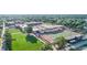 Aerial view of a school football field and track surrounded by academic buildings and lush green space at 2186 Park Terrace, College Park, GA 30337