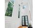 Bright, two-story foyer with large windows, chandelier, and modern paneled walls for a grand entrance at 2186 Park Terrace, College Park, GA 30337