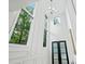 Bright and airy foyer with soaring windows, stylish chandelier, and elegant architectural details at 2186 Park Terrace, College Park, GA 30337
