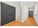 Inviting hallway featuring wood floors, staircase and modern black doors at 2186 Park Terrace, College Park, GA 30337