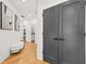 Hallway with light wood floors, white walls, and modern decor at 2186 Park Terrace, College Park, GA 30337