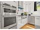 Kitchen with stainless steel appliances and white cabinetry at 2186 Park Terrace, College Park, GA 30337