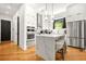 Modern kitchen featuring stainless steel appliances, a large island, and sleek white cabinets at 2186 Park Terrace, College Park, GA 30337