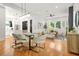Open-concept living room with hardwood floors, modern lighting, and large windows offering ample natural light at 2186 Park Terrace, College Park, GA 30337