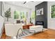 Cozy living room featuring hardwood floors, modern decor, natural light, and sleek fireplace at 2186 Park Terrace, College Park, GA 30337