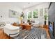 Bright living room with hardwood floors, neutral furniture, and large windows at 2186 Park Terrace, College Park, GA 30337