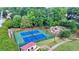 Aerial view of well-maintained tennis courts, playground, and green space surrounded by lush trees in a community setting at 2186 Park Terrace, College Park, GA 30337