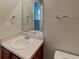 Bathroom vanity and sink with a mirror and wooden cabinets at 2429 Wood Bend Ln, Riverdale, GA 30296