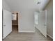 Open view of bedroom with multiple doorways and wood-look flooring at 2429 Wood Bend Ln, Riverdale, GA 30296