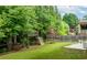 Spacious backyard with lush lawn, treehouse, landscaping, and privacy fence at 3016 Levinshire Way, Dacula, GA 30019