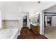 This bathroom showcases a large soaking tub, a vanity, a mirror, and a separate walk-in closet at 3016 Levinshire Way, Dacula, GA 30019