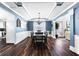 Dining room boasts hardwood floors, wainscoting detail, and modern chandelier at 3016 Levinshire Way, Dacula, GA 30019
