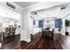 Dining room with elegant lighting, wainscoting, and hardwood floors, connecting to the kitchen at 3016 Levinshire Way, Dacula, GA 30019