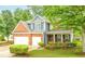 Traditional two-story home with brick and siding, two-car garage and manicured landscaping at 3016 Levinshire Way, Dacula, GA 30019