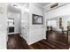 Hallway with wood floors leading to a bathroom and the main living areas at 3016 Levinshire Way, Dacula, GA 30019