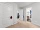 Hallway featuring neutral walls, white trim, and doorways leading to other rooms in the house at 3016 Levinshire Way, Dacula, GA 30019