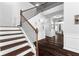 Elegant staircase showcasing wood steps, white risers, and modern black iron spindles at 3016 Levinshire Way, Dacula, GA 30019