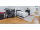 Bright bedroom featuring hardwood floors, a serene atmosphere, and a dedicated workspace at 1150 Collier Nw Rd # 25D, Atlanta, GA 30318