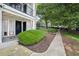 Charming condo building with well-manicured bushes and convenient walkway access at 1150 Collier Nw Rd # 25D, Atlanta, GA 30318