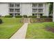 Exterior view of community with landscaped grounds and stair access to upper-level residences at 1150 Collier Nw Rd # 25D, Atlanta, GA 30318