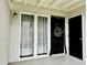 Charming entryway with a black front door and decorative wreath, adjacent to bright windows at 1150 Collier Nw Rd # 25D, Atlanta, GA 30318