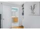 Hallway leading to the bathroom with white doors and open shelving at 1150 Collier Nw Rd # 25D, Atlanta, GA 30318