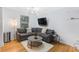 Cozy living room featuring a large sectional, modern lighting, and a comfortable rug at 1150 Collier Nw Rd # 25D, Atlanta, GA 30318