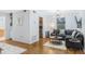 Open-concept living space with hardwood floors, a gray sectional and stainless steel appliances at 1150 Collier Nw Rd # 25D, Atlanta, GA 30318