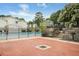 Community pool area with brick patio, stone retaining wall, and a convenient barbecue grill at 1150 Collier Nw Rd # 25D, Atlanta, GA 30318