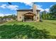 Enjoy this spacious backyard, featuring a covered patio, a lush lawn, and a serene wooded backdrop at 2102 Braswell Ln, Loganville, GA 30052