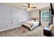 This cozy bedroom features built-in storage, ceiling fan and plush carpet for a comfortable and inviting atmosphere at 2102 Braswell Ln, Loganville, GA 30052