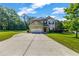 Charming home featuring a well-maintained lawn, long driveway, and attached garage at 2102 Braswell Ln, Loganville, GA 30052