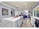 Open kitchen layout with an island, barstools, and a view of the adjacent living room at 2102 Braswell Ln, Loganville, GA 30052