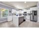 Modern kitchen featuring white cabinets, stainless steel appliances, and an island at 2102 Braswell Ln, Loganville, GA 30052