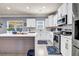 Modern kitchen with island, stainless steel appliances, and updated finishes at 2102 Braswell Ln, Loganville, GA 30052