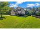 Beautifully kept lawn with mature trees surrounding the home at 2102 Braswell Ln, Loganville, GA 30052