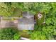 An aerial view of the residence showcasing mature trees, a driveway, roof, firepit, and surrounding foliage at 2804 Dunnington Cir, Chamblee, GA 30341