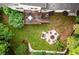 An aerial view of the backyard with patio seating area, deck and mature trees at 2804 Dunnington Cir, Chamblee, GA 30341