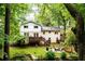 Back of house with deck, stairs, firepit and lush trees providing privacy and shade at 2804 Dunnington Cir, Chamblee, GA 30341