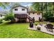 Spacious backyard featuring a raised deck and patio with a fire pit, ideal for outdoor entertaining at 2804 Dunnington Cir, Chamblee, GA 30341