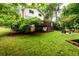 Large backyard with deck, fire pit and mature trees providing privacy and shade at 2804 Dunnington Cir, Chamblee, GA 30341